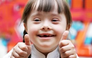 Portrait of beautiful happy girl giving thumbs up.